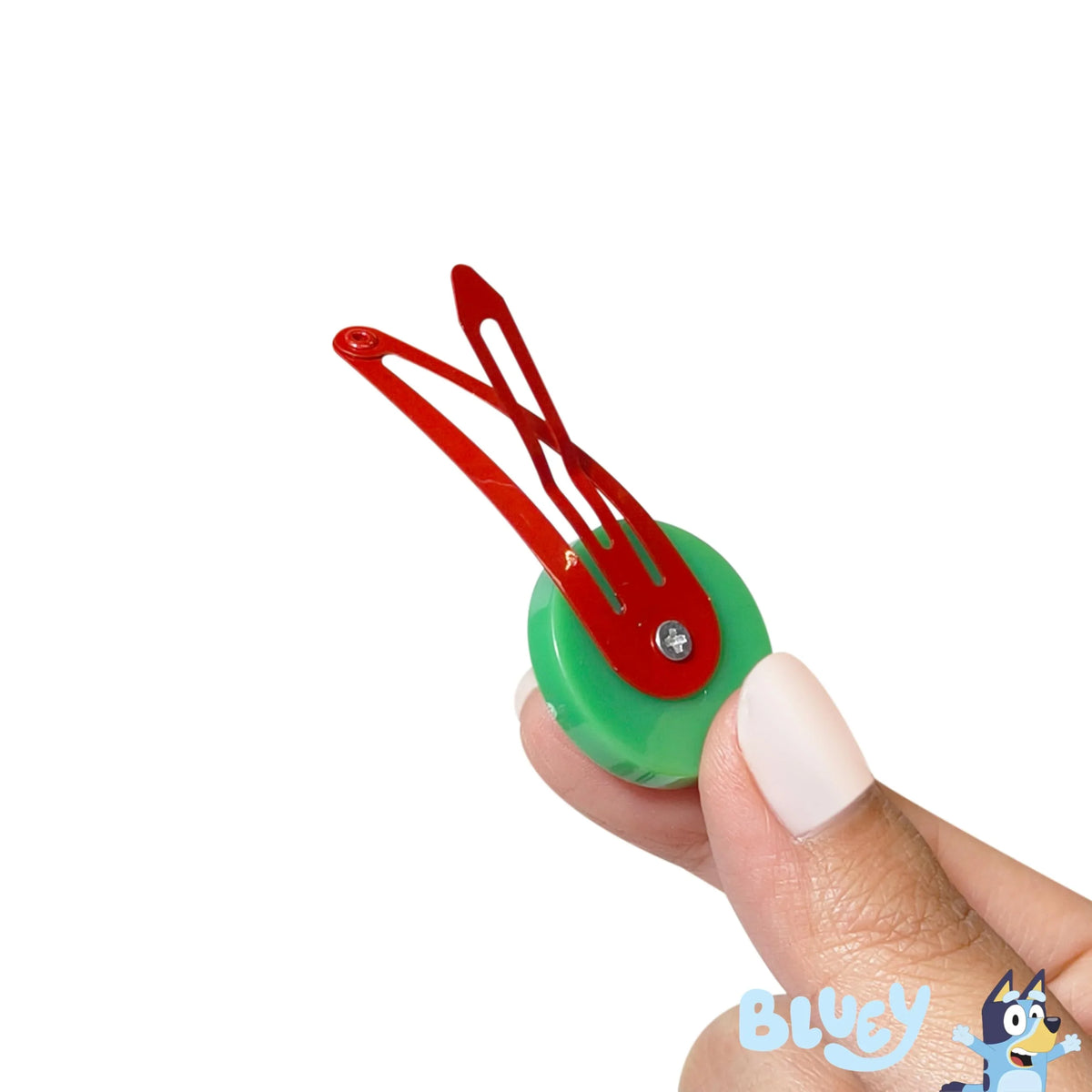Bluey hair clip by LuvHer Shop with red metal clasp and green base, held in hand