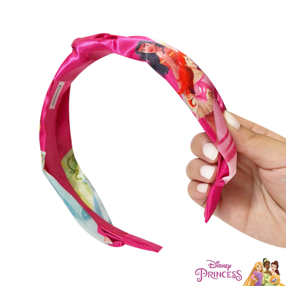 Disney Princess pink headband for girls featuring princess characters, held in hand