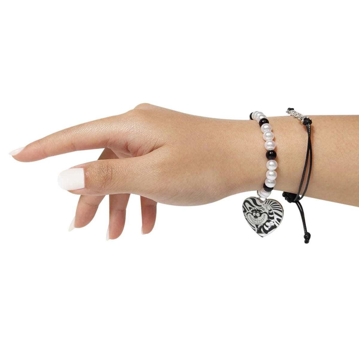 Cheshire Cat heart charm bracelet with black and white beads on a model hand from LuvHer Shop