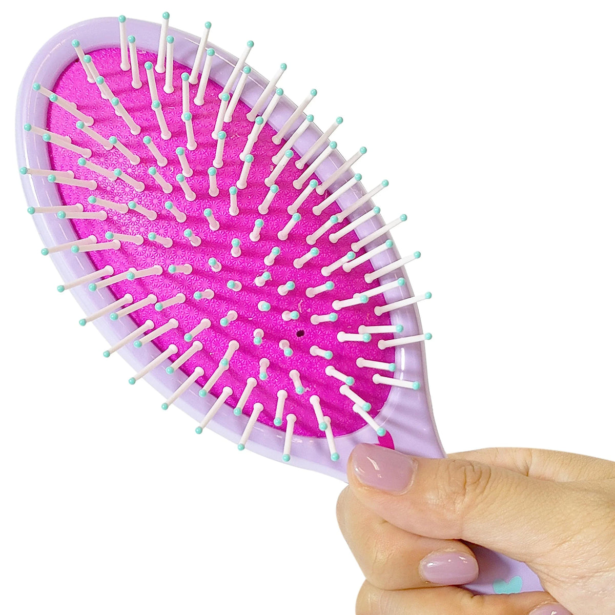 LuvHer Shop pink and purple girl's hair brush with bristles, held in hand, kids accessory