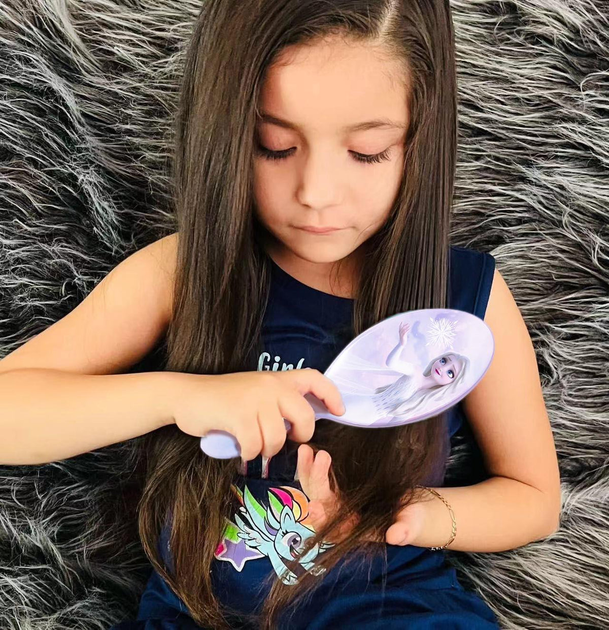 Girl using Frozen Elsa hair brush from LuvHer Shop, long hair, furry rug background