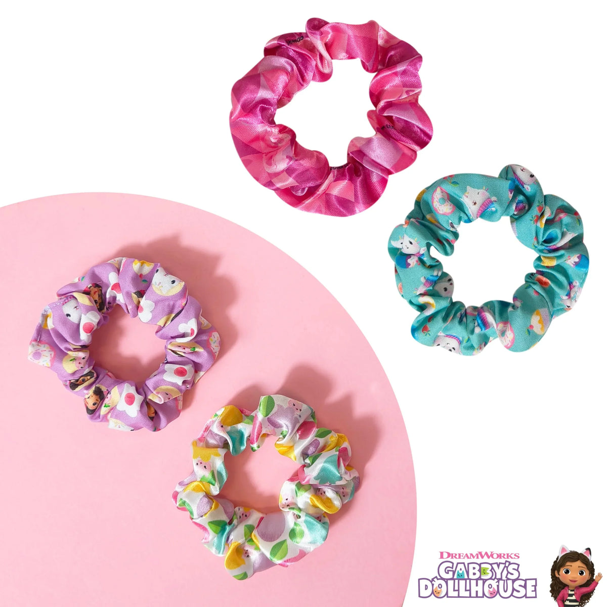 Gabby's Dollhouse scrunchies set featuring colorful, patterned hair accessories on white and pink background