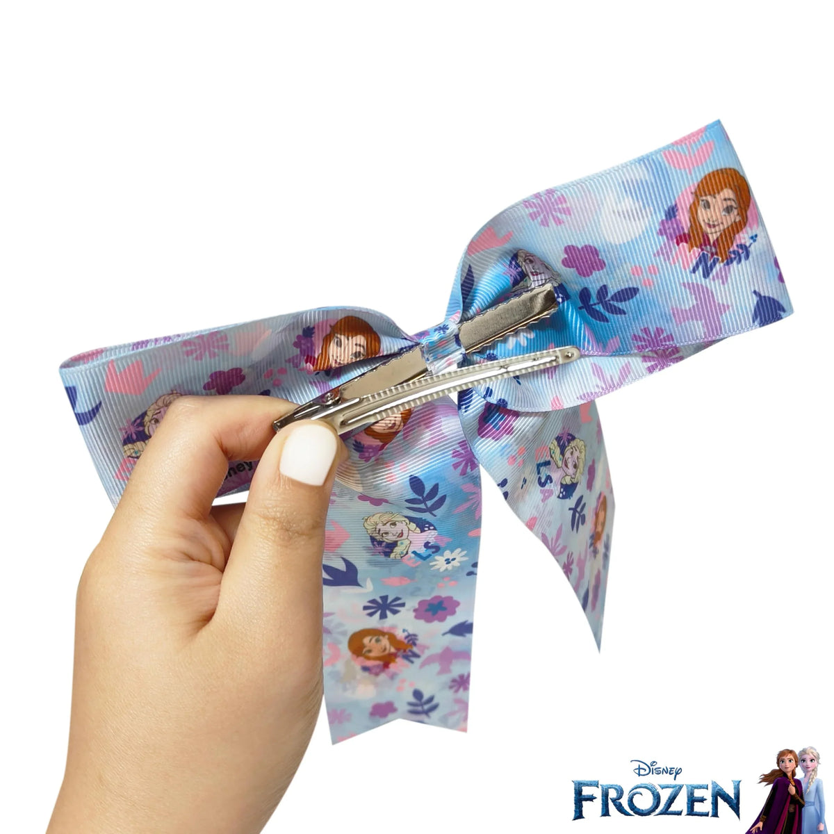 Disney Frozen hair bow with Anna and Elsa design, held in hand, girls' accessory from LuvHer Shop
