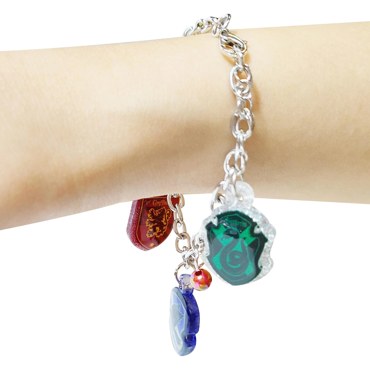 Harry Potter House Crest Charm Bracelet with colorful charms on wrist from LuvHer Shop