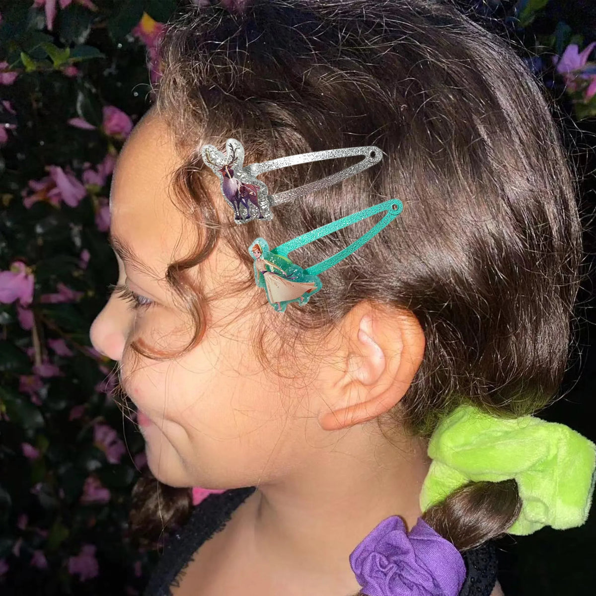 Girl wearing Frozen Snap Hair Clips with Anna and Sven, side profile with colorful scrunchies